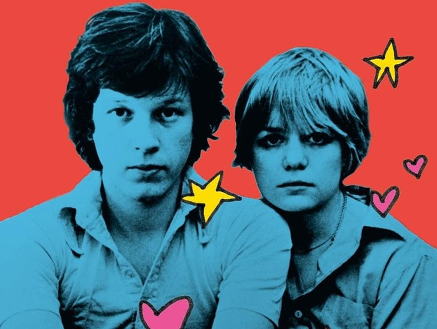 A portrait of Chris Frantz and Tina Weymouth sitting next to each other. Their bodies are colorized blue and the background is red. 